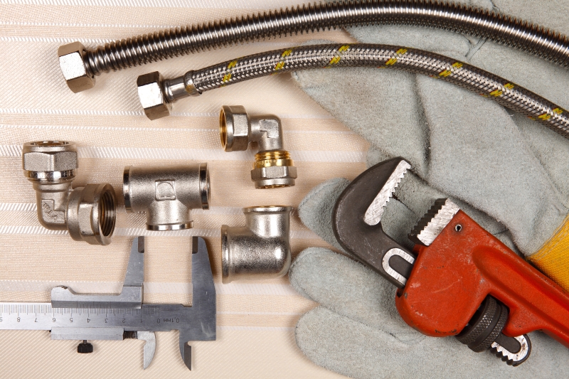 Plumber working on pipes in a Waltham Abbey home